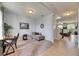 Bright home office with neutral carpet, comfortable seating, and view into the living room at 12328 Streambed Dr, Riverview, FL 33579
