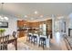 Modern kitchen island with seating, pendant lighting and wood cabinets with stainless steel appliances at 12328 Streambed Dr, Riverview, FL 33579