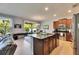Open concept kitchen with island seating, stainless steel appliances and access to dining and living area at 12328 Streambed Dr, Riverview, FL 33579