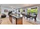 Kitchen island featuring granite countertops, stainless steel appliances, and a seamless transition into the living area at 12328 Streambed Dr, Riverview, FL 33579