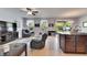 Open-concept living room with a leather sofa, large windows, ceiling fan and views to the outside patio at 12328 Streambed Dr, Riverview, FL 33579