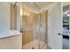 Bathroom showcasing glass-enclosed shower and entry to the bedroom at 12328 Streambed Dr, Riverview, FL 33579