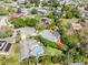 Aerial view showcasing homes with pools, lush landscaping, and proximity to cul-de-sac at 13420 Rustic Pines S Blvd, Seminole, FL 33776