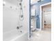 Bright bathroom featuring a white tiled shower and mosaic accent tiles at 13420 Rustic Pines S Blvd, Seminole, FL 33776