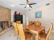 Inviting dining room with stone fireplace, sleek black wine cooler, and tiled floor at 13420 Rustic Pines S Blvd, Seminole, FL 33776