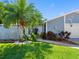 Inviting home featuring a lush front yard, mature palm trees, and a well-maintained facade at 13420 Rustic Pines S Blvd, Seminole, FL 33776