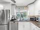 Well-lit kitchen offers stainless steel appliances and a window view of the pool at 13420 Rustic Pines S Blvd, Seminole, FL 33776