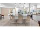 Elegant kitchen featuring a large island, breakfast bar seating, and stainless steel appliances at 13420 Rustic Pines S Blvd, Seminole, FL 33776