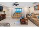 Spacious living room with tile flooring, comfortable seating, and large windows at 13420 Rustic Pines S Blvd, Seminole, FL 33776
