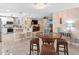 Open-concept living space featuring a dining area and an expansive kitchen with bar seating at 13420 Rustic Pines S Blvd, Seminole, FL 33776