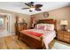 Comfortable main bedroom features wood floors, a ceiling fan, and coastal-themed decorations at 13420 Rustic Pines S Blvd, Seminole, FL 33776