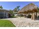 Tiki hut with entertainment area and a boat parking area in a beautifully landscaped backyard at 143 58Th S Ave, St Petersburg, FL 33705