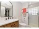 Bathroom showcasing a vanity with modern fixtures, a white toilet, and a tiled shower at 15112 Alexis Dr, Tampa, FL 33624