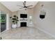 Bright living area featuring a fireplace and ample natural light from sliding glass doors at 15112 Alexis Dr, Tampa, FL 33624