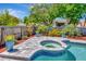 Beautiful pool area with a spa, well-maintained patio, and lush tropical landscaping at 15112 Alexis Dr, Tampa, FL 33624