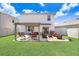 Spacious backyard with a furnished patio area and lush green lawn at 16316 Silent Sands Ln, Odessa, FL 33556