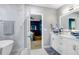 Bright bathroom with tub, double vanity sinks, and an open view to the bedroom at 16316 Silent Sands Ln, Odessa, FL 33556