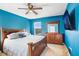 Bedroom with ceiling fan, dresser, and large bed at 16316 Silent Sands Ln, Odessa, FL 33556
