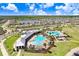 An aerial view of the community pools amidst manicured lawns shows off an amenity for residents at 16316 Silent Sands Ln, Odessa, FL 33556