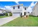 Charming two-story home with a well-manicured lawn and inviting curb appeal, plus an attached two-car garage at 16316 Silent Sands Ln, Odessa, FL 33556