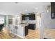 Modern kitchen with granite countertops, stainless steel appliances, and breakfast bar at 16316 Silent Sands Ln, Odessa, FL 33556