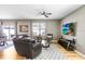 The bright living room boasts a comfortable seating arrangement with a large window and a view to the outside at 16316 Silent Sands Ln, Odessa, FL 33556