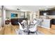 Open-concept living room and kitchen with wood floors and comfortable seating at 16316 Silent Sands Ln, Odessa, FL 33556