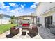 Outdoor patio featuring comfortable seating under a pergola, perfect for entertaining at 16316 Silent Sands Ln, Odessa, FL 33556