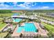 Aerial view of a sparkling pool and sundeck with lounge chairs at this recreational community center at 16316 Silent Sands Ln, Odessa, FL 33556