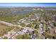 Panoramic aerial view showcasing a residential neighborhood with a lake and cityscape in the background at 1766 10Th Sw St, Largo, FL 33778