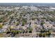 Expansive aerial view of a dense residential neighborhood with mature trees and a clear blue sky above at 1766 10Th Sw St, Largo, FL 33778