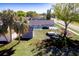 Aerial view of a home showcasing the backyard, shed, and patio with a gazebo and a fire pit at 1766 10Th Sw St, Largo, FL 33778