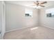Bedroom with carpeted floors, two windows, neutral paint, and a ceiling fan at 1766 10Th Sw St, Largo, FL 33778