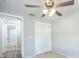 Bedroom with ceiling fan, carpet, closet, and access to the bathroom at 1766 10Th Sw St, Largo, FL 33778
