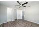 Bedroom featuring wood-look floors, neutral paint, ceiling fan, closet, and bathroom access at 1766 10Th Sw St, Largo, FL 33778