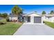 Charming single-story home features a well-manicured lawn, gray exterior paint, and an attached garage at 1766 10Th Sw St, Largo, FL 33778