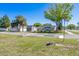 Exterior shot showcasing the home, complemented by mature trees and lush landscaping at 1766 10Th Sw St, Largo, FL 33778