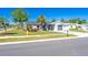 Charming single-story home with a well-manicured lawn and mature landscaping and grey exterior paint at 1766 10Th Sw St, Largo, FL 33778