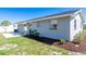 Home exterior features a sliding glass door to a patio and landscaped yard with mulch beds at 1766 10Th Sw St, Largo, FL 33778