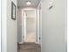 Hallway with wood-look floors leading to a bedroom at 1766 10Th Sw St, Largo, FL 33778