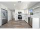 Modern kitchen featuring stainless appliances, white cabinets, and laminate floors at 1766 10Th Sw St, Largo, FL 33778