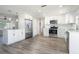 Bright kitchen featuring stainless appliances, white shaker cabinets, laminate floors, and a peninsula at 1766 10Th Sw St, Largo, FL 33778