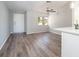 Bright living room boasts modern gray laminate flooring and a ceiling fan at 1766 10Th Sw St, Largo, FL 33778