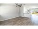 Sunlit living space featuring gray floors, white walls and trim, and modern ceiling fan at 1766 10Th Sw St, Largo, FL 33778