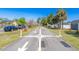 A scenic street with a tree-lined sidewalk and well-maintained greenery, with houses on either side at 1766 10Th Sw St, Largo, FL 33778