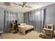 Cozy bedroom with a ceiling fan, gray walls and unique decor accents at 1988 58Th N St, St Petersburg, FL 33710