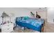 Bedroom featuring a bed with blue patterned covers, a nightstand, and an open doorway to another room at 1988 58Th N St, St Petersburg, FL 33710