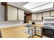 Nostalgic kitchen featuring wood cabinets, laminate countertops, double sink and standard appliances at 1988 58Th N St, St Petersburg, FL 33710