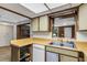 Functional kitchen featuring wood countertops, basic appliances, and a pass-through window into another room at 1988 58Th N St, St Petersburg, FL 33710