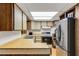 Vintage kitchen with wood cabinets, laminate countertops, a full appliance suite, and ample storage space at 1988 58Th N St, St Petersburg, FL 33710